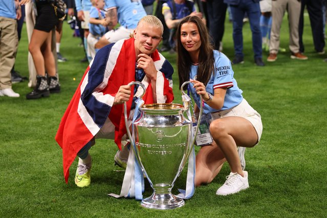 Erling Haaland of Manchester City and Isabel Johansen pose with the trophy after the UEFA Champions League 2022/23 final match between Manchester City FC and FC Internazionale at Ataturk Olympic Stadium on June 10, 2023 in Istanbul, Turkey. (Photo by Marc Atkins/Getty Images)