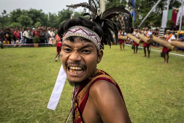 An Indian Garo tribal in traditional attire performs a traditional dance during Baikho festival at Gamerimura village along the Assam Meghalaya border, west of Gauhati, India, Saturday, June 4, 2022. (Photo by Anupam Nath/AP Photo)
