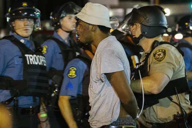 St Louis County police officers arrest an anti-police demonstrator in Ferguson, Missouri August 10, 2015. (Photo by Lucas Jackson/Reuters)