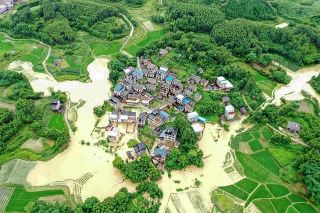 This aerial photo taken on June 13, 2022 shows flooded fields and buildings following heavy rains in Rongan in China's southern Guangxi region. (Photo by AFP Photo/China Stringer Network)