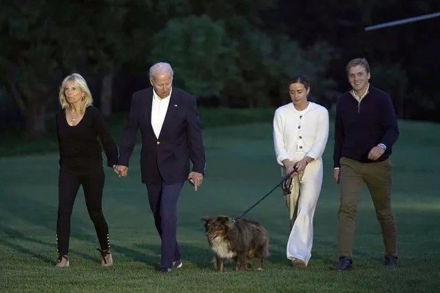 President Joe Biden and fist lady Jill Biden, left, walk with their granddaughter Naomi Biden, second from right, and her finace , Peter Neal, right, and Neal's dog Charlie, across the South Lawn of the White House in Washington, Monday, June 20, 2022, as they return from a weekend at the Biden's beach home in Delaware. (Photo by Susan Walsh/AP Photo)