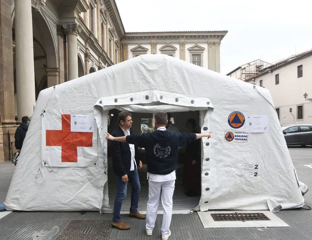 A pre-triage medical tent is set up in front of the Santa Maria Nuova hospital in Florence, Italy, 25 February 2020. The tent's purpose is to sanitize the ambulance arrival area amid the ongoing outbreak of the SARS-CoV-2 coronavirus that causes the COVID-19 disease. At least 228 cases have been reported in Italy so far, most of them concentrated in the northern Lombardy and Veneto regions. The disease has killed at least seven people in the Mediterranean country, according to official reports. (Photo by Claudio Giovannini/EPA/EFE)