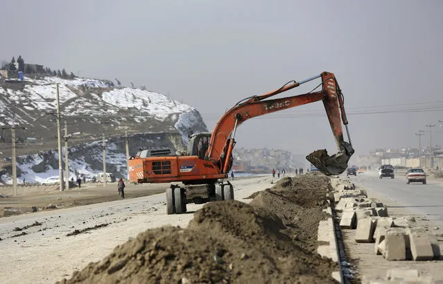 In this Monday, February 10, 2020 photo, an excavator works on road construction project funded by the government, in Kabul, Afghanistan. Rebuilding war-ravaged Afghanistan has cost thousands of lives according to a new report released Monday by a U.S. government watchdog that monitors the billions of U.S. dollars spent reconstructing Afghanistan. (Photo by Rahmat Gul/AP Photo)