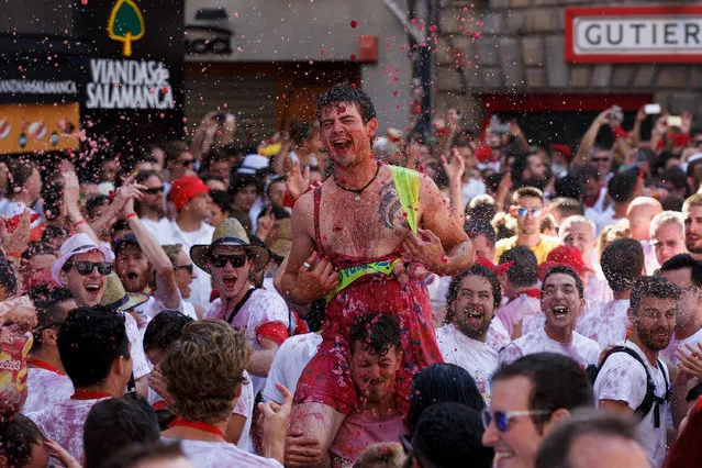 Revellers enjoy the atmosphere during the opening day or “Chupinazo” of the San Fermin Running of the Bulls fiesta on August 6, 2016 in Pamplona, Spain. The annual Fiesta de San Fermin, made famous by the 1926 novel of US writer Ernest Hemmingway entitled “The Sun Also Rises”, involves the daily running of the bulls through the historic heart of Pamplona to the bull ring. (Photo by Pablo Blazquez Dominguez/Getty Images)