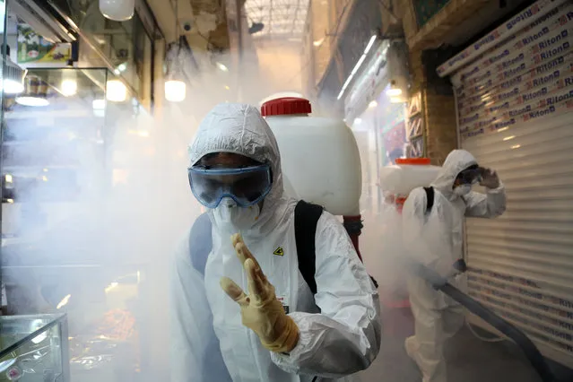 Fire fighter teams with protective suits disinfect the Tajrish Bazaar as a precaution to the coronavirus (Covid-19) in Tehran, Iran on March 06, 2020. A Health Ministry spokesman warned authorities could use unspecified force to halt travel between major cities. (Photo by Fatemeh Bahrami/Anadolu Agency via Getty Images)