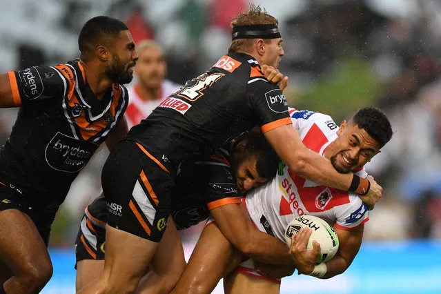 Timoteo Lafai of the Dragons is tackled by Alex Twal and Luke Garner of the Tigers during the Round One NRL match between St George Illawarra Dragons and Wests Tigers at WIN Stadium in Wollongong, Sunday, March 15, 2020. (Photo by Dean Lewins/AAP Image)