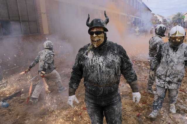People covered in flour celebrate the traditional fest called “The floured ones” (Els Enfarinats) in Ibi, Alicante, Valencia, Spain, 28 December 2024. The fest is celebrated during the “Dia de los Santos Inocentes” (Saint Innocents Day), the Spanish version of April Fools' Day, and people battle among themselves with fireworks, flour and eggs. (Photo by Pablo Miranzo/EPA/EFE)