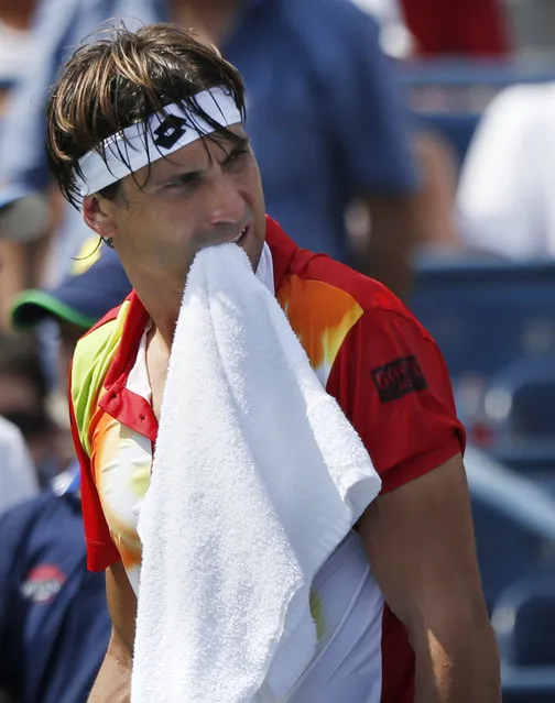 David Ferrer, of Spain, walks to his chair during a break between games against Gilles Simon, of France, during the third round of the 2014 U.S. Open tennis tournament, Sunday, August 31, 2014, in New York. (Photo by Seth Wenig/AP Photo)