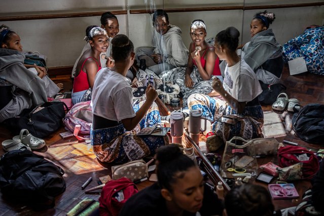 Senior company members of the Dance Centre Kenya (DCK) prepare backstage as they get their makeup done ahead of their performance in The Nutcracker at the Kenya National Theatre in Nairobi on December 7, 2024. The Nutcracker is a beloved Christmas ballet, first performed in 1892, with music by Pyotr Ilyich Tchaikovsky. Known for its enchanting score and festive themes, it has become a holiday tradition worldwide. (Photo by  Luis Tato/AFP Photo)