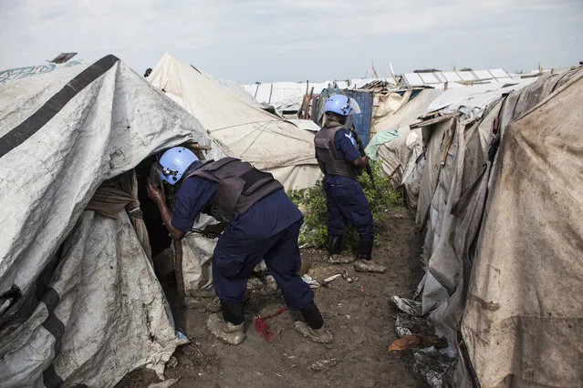 Members of the United Nations Police, UNPOL, search shelters for contraband in the Protection of Civilians (POC) site at the United Nations Mission in South Sudan (UNMISS) compound in Malakal, South Sudan on Friday, July 15, 2016. (Photo by Jane Hahn/The Washington Post)