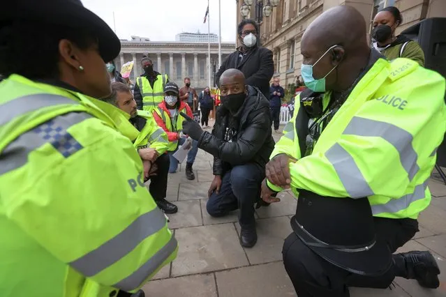 Police officers listen to a demonstrator as they kneel during the Black Lives Matter protest, following the death of George Floyd who died in police custody in Minneapolis, in Birmingham, Britain, June 19, 2020. (Photo by Carl Recine/Reuters)