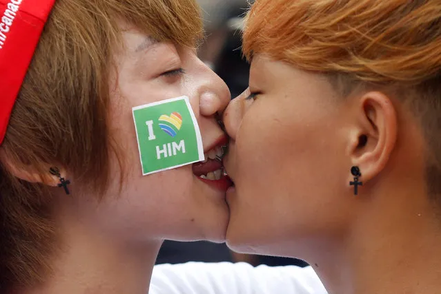 Participants Mo Ngoc (L) and Khanh Bi kiss each other at the 5th annual LGBT (Lesbian, Gay, Bisexual  and Transgender) pride parade entitled “Viet Pride – Path of Pride” at American Club in Hanoi, Vietnam August 21, 2016. (Photo by Reuters/Kham)