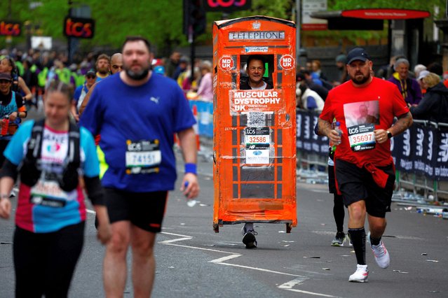 Runner Sid Keyte dressed as a telephone box in action during the London Marathon in London, Britain, on April 21, 2024. (Photo by John Sibley/Reuters)