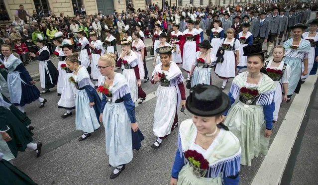 Women dressed in traditional Bavarian clothes take part in the Oktoberfest parade in Munich, Germany, September 20, 2015. (Photo by Lukas Barth/Reuters)