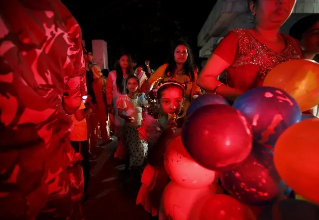 Nepalese people holding balloons walk out from the parliament after President Ram Baran Yadav promulgated the constitution at the parliament in Kathmandu, Nepal September 20, 2015. (Photo by Navesh Chitrakar/Reuters)