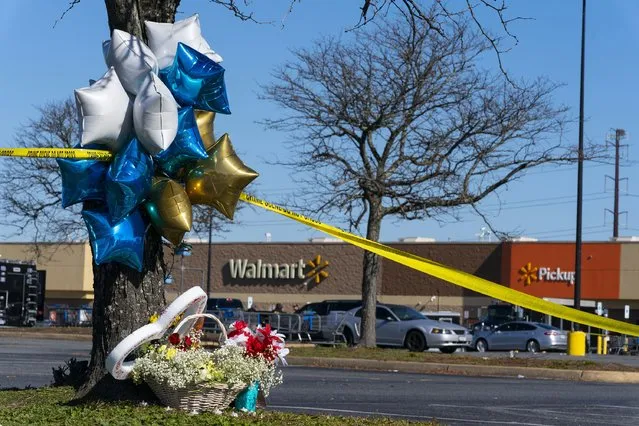 Flowers and balloons have been placed near the scene of a mass shooting at a Walmart, Wednesday, November 23, 2022, in Chesapeake, Va. A Walmart manager opened fire on fellow employees in the break room of the Virginia store, killing several people in the country’s second high-profile mass shooting in four days, police and witnesses said Wednesday. (Photo by Alex Brandon/AP Photo)