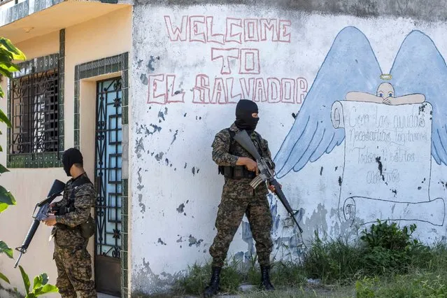 In this Monday, August 31, 2015 photo, soldiers guard a corner in a gang-controlled neighborhood in Ilopango, El Salvador. (Photo by Salvador Melendez/AP Photo)