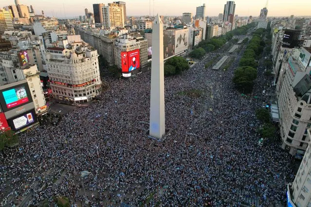 In this aerial view, fans of Argentina celebrate their team's victory after the Qatar 2022 World Cup semifinal football match between Croatia and Argentina at the Obelisk in Buenos Aires on December 13, 2022.  (Photo by Emiliano Lasalvia/AFP Photo)