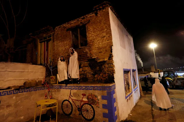 Revellers wrapped in white sheets stand on an abandoned house during the “Bocuk night”, or the Thracian Halloween, in Camlica village, near the western town of Kesan, Turkey, January 6, 2018. (Photo by Murad Sezer/Reuters)
