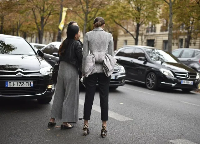 Unidentified fashion lovers leave after Miu Miu's Spring-Summer 2016 ready-to-wear fashion collection presented during the Paris Fashion Week, Wednesday, October 7, 2015 in Paris, France. (Photo by Zacharie Scheurer/AP Photo)