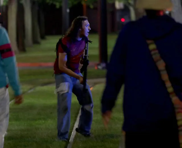 An armed man is seen outside the Kenosha County Courthouse in Kenosha on Sunday, August 23, 2020. Kenosha police shot a man Sunday evening, setting off unrest in the city. (Photo by Mike De Sisti/Milwaukee Journal Sentinel via USA Today Network/Sipa USA)