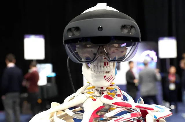 A skeleton with a Microsoft HoloLens 2 draws attention to the Abys Medical booth, designers of platform allowing for holographic assistance to surgeons during operations, during the CES Unveiled press event at CES 2023, an annual consumer electronics trade show, in Las Vegas, Nevada, U.S. January 3, 2023. (Photo by Steve Marcus/Reuters)