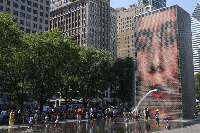 People cool off in Crown Fountain in Millennium Park as temperatures climbed to over 95 degrees Fahrenheit (35 degrees Celsius), in Chicago, Illinois, on June 21, 2025. Excessive heat is expected in the area for the next few days. (Photo by Kamil Krzaczynski/AFP Photo)