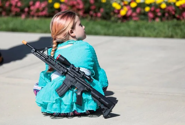 A young girl wears a toy weapon during a “2nd Amendment” rally at the Michigan State Capitol in Lansing, Michigan, U.S. September 17, 2020. (Photo by Rebecca Cook/Reuters)