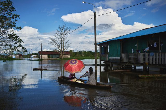 A woman sells slices of cake with her daughter from a canoe in Belen, a district nicknamed “Venice of the Jungle” in Iquitos, Peru, Sunday, May 25, 2025. (Photo by Rodrigo Abd/AP Photo)