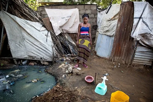 Mozambique. Assucena, 14, is a Grade 8 student who loves to study and play football. She lives with her mother, grandmother, sister and two cousins. Her grandmother sells beer to provide for her extended family. Assucena shares a toilet with more than 30 other people from different families. “When it rains, the toilet floods. It really smells bad”. (Photo by James Oatway/WSUP/Panos)