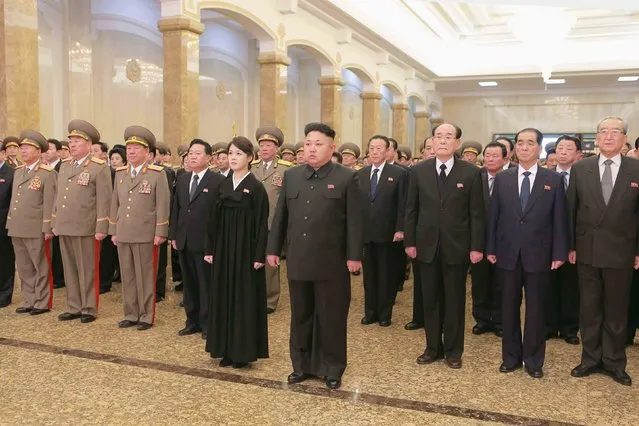 North Korean leader Kim Jong Un (C) and wife Ri Sol Ju visit the Kumsusan Palace of the Sun to mark the third anniversary of the death of Kim Jong Il in this undated photo released by North Korea's Korean Central News Agency (KCNA) in Pyongyang December 17, 2014. (Photo by Reuters/KCNA)