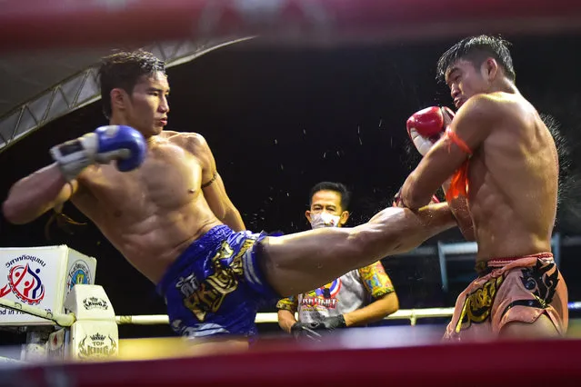 This picture taken on September 26, 2020 shows Muay Thai fighters competing in a match in Rueso district in Thailand's southern province of Narathiwat. (Photo by Madaree Tohlala/AFP Photo)