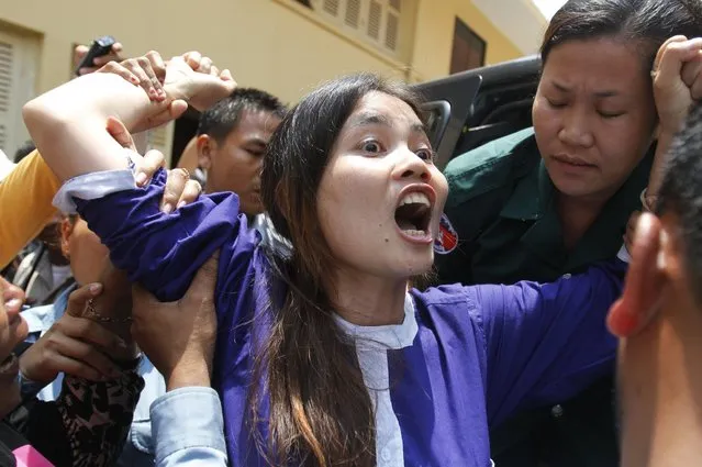 Boeung Kak Lake resident Yorm Bopha (C) reacts after she was denied bail at a hearing in the Supreme Court in the capital city of Phnom Penh March 27, 2013. The residents of Boeung Kak Lake have been embroiled in a long-running land dispute with a real estate development firm in the capital and have also been appealed for Bopha's release from prison. (Photo by Samrang Pring/Reuters)
