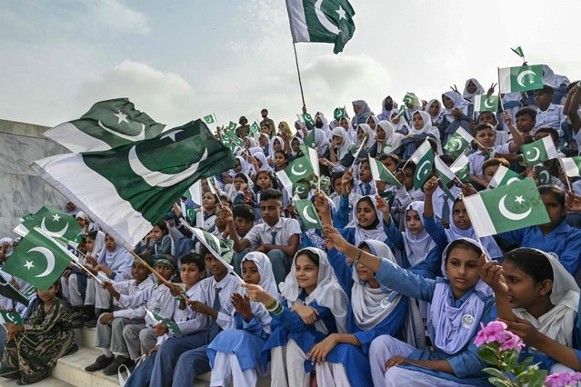 Students wave Pakistan's national flags during Independence Day celebrations at the mausoleum of the country's founding father, Muhammad Ali Jinnah, in Karachi on August 14, 2025. (Photo by Asif Hassan/AFP Photo)