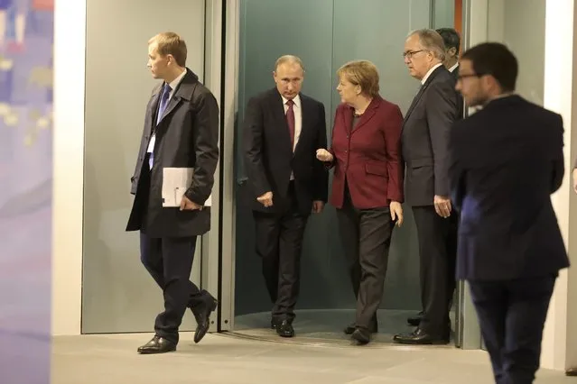 German Chancellor Angela Merkel walks with Russian President Vladimir Putin as they arrive for talks on a stalled peace plan for eastern Ukraine at the chancellery in Berlin, Germany, October 19, 2016. (Photo by Michael Kappeler/Reuters)