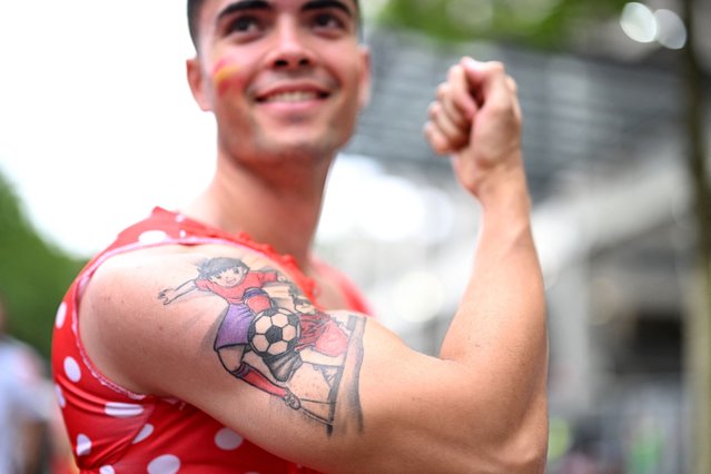 A Spain's supporter shows his tattoo in tribute to the Japanese manga 'Captain Tsubasa' ahead of the UEFA Euro 2024 round of 16 football match between Spain and Georgia at the Cologne Stadium in Cologne on June 30, 2024. (Photo by Kirill Kudryavtsev/AFP Photo)