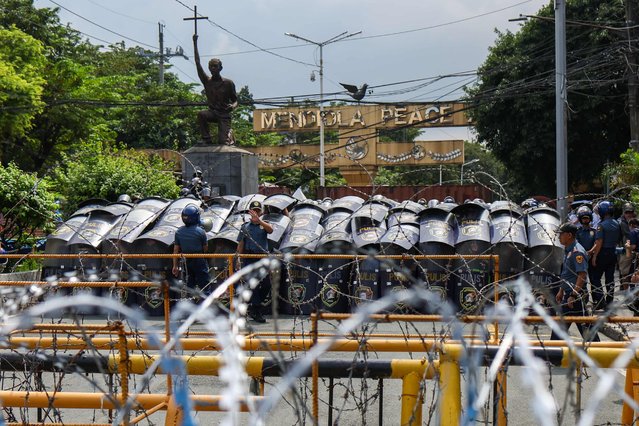 Riot police officers shield up as protesters gather, during a demonstration against corruption under President Ferdinand Marcos Jr's administration, in Manila, Philippines on October 21, 2025. The demonstration is part of the Southeast Asian country's growing public outrage over exposed corruption in nationwide flood-control infrastructure projects worth of more than 9 billion U.S. dollars under Ferdinand Marcos Jr's administration, with young people as the majority staging protests with One Piece flags, joining a global trend of anti-government protests led by Gen-Z including those in Nepal and Indonesia. (Photo by Daniel Ceng/Anadolu via Getty Images)