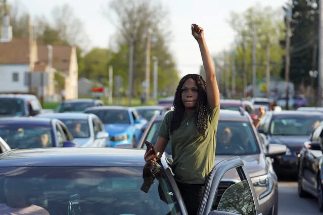 A woman holds her fist up during a protest held after a grand jury voted against indicting police officers in the fatal shooting of unarmed Black man Jayland Walker, in Akron, Ohio, U.S. April 19, 2023. (Photo by Dieu-Nalio Chery/Reuters)