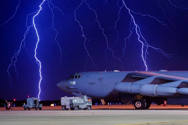 Lightning strikes behind a B-52H Stratofortress at Minot Air Force Base, North Dakota, U.S. on August 8, 2017. (Photo by Courtesy J.T. Armstrong/Reuters/U.S. Air Force)