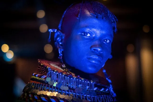 A dancer of Turkana tribe performs in blue light during the launching ceremony of the 11th Marsabit-Lake Turkana Cultural Festival in Nairobi, Kenya, on June 20, 2018. The annual festival will take place between June 28 and 30, 2018, featuring the cultural traditions of 14 ethnic tribes in Marsabit county, the nothern part of Kenya, to promote tourism and their social inclusiveness. (Photo by Yasuyoshi Chiba/AFP Photo)