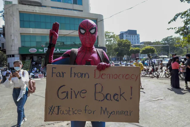 A demonstrator in a costume flashes three-fingered salute, a symboled of resistance, in Yangon, Myanmar Wednesday, February 10, 2021. Protesters continued to gather Wednesday morning in Yangon breaching Myanmar's new military rulers' decrees that effectively banned peaceful public protests in the country's two biggest cities. (Photo by AP Photo/Stringer)