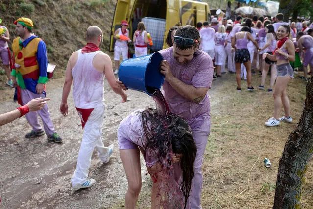 A reveller has wine poured over her during the Batalla de Vino (Wine Battle) in Haro, Spain, June 29, 2018. (Photo by Vincent West/Reuters)