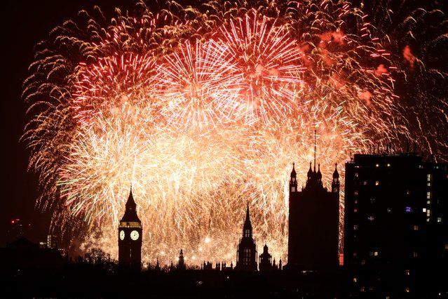Fireworks explode in the sky around the London Eye and The Elizabeth Tower, commonly known by the name of the clock's bell, “Big Ben”, at the Palace of Westminster, home to the Houses of Parliament, in central London, just after midnight on January 1, 2025. (Photo by Adrian Dennis/AFP Photo)