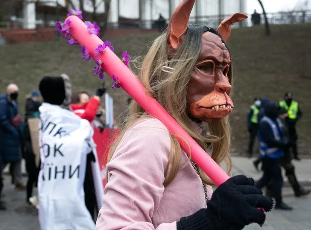 An activist takes part in a rally for gender equality and against violence towards women on International Women's Day in Kyiv, Ukraine on March 8, 2021. (Photo by Anastasia Vlasova/Reuters)