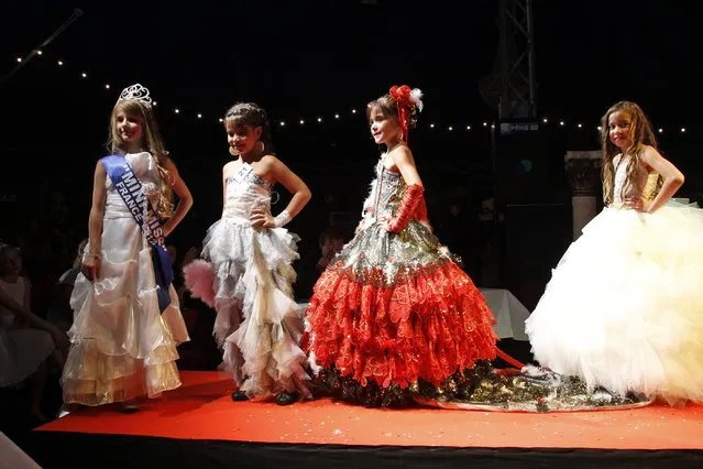 Contestants walk on stage during the “mini-miss” beauty contest in Bobigny, Paris suburb, September 22, 2012. The competition is open for girls aged 7 to 12. (Photo by Benoit Tessier/Reuters)