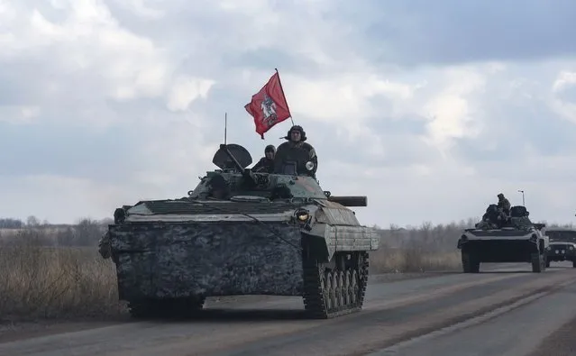 Members of the separatist self-proclaimed Donetsk People's Republic drive armoured vehicles, with Saint George slaying the Dragon displayed on a red flag, near Yenakiieve, Donetsk region, February 4, 2015. The coat of arms of the Russian capital Moscow depicts St. George the Victorious atop a silver horse slaying a black dragon with silver harness, according to the official web site of Moscow city government. (Photo by Maxim Shemetov/Reuters)