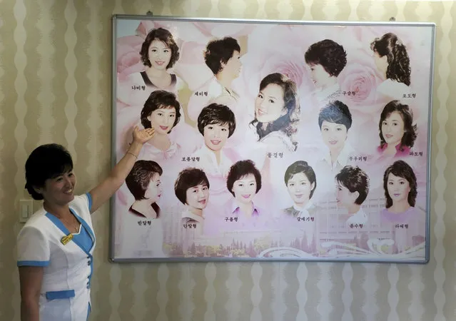 A guide shows hairstyles for women hanging on the wall at a hair salon at the Munsu Water Park during in Pyongyang, North Korea, Tuesday, July 24, 2018. (Photo by Dita Alangkara/AP Photo)