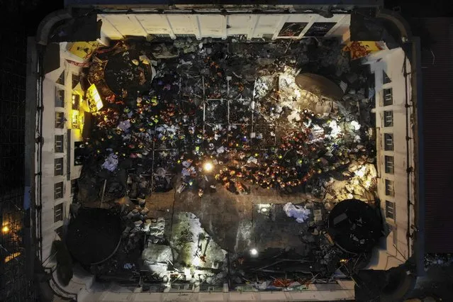 In this photo released by Xinhua News Agency, an aerial view shows rescuers conducting search and rescue operation at the site of a roof collapsed middle school gymnasium in Qiqihar, in northeast China's Heilongjiang Province on Monday, July 24, 2023. More than 10 people were killed when a roof collapsed at a middle school gymnasium in China's far northeast, authorities said Monday. (Photo by Wang Song/Xinhua via AP Photo)