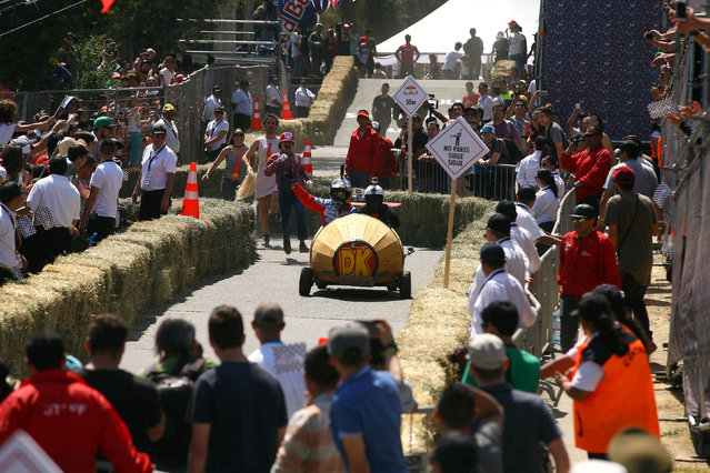 Competitors ride a home-made vehicle without an engine on a downhill track in the Red Bull Soapbox Race in Santiago, Chile, November 27, 2016. (Photo by Jonathan Faus/Reuters)
