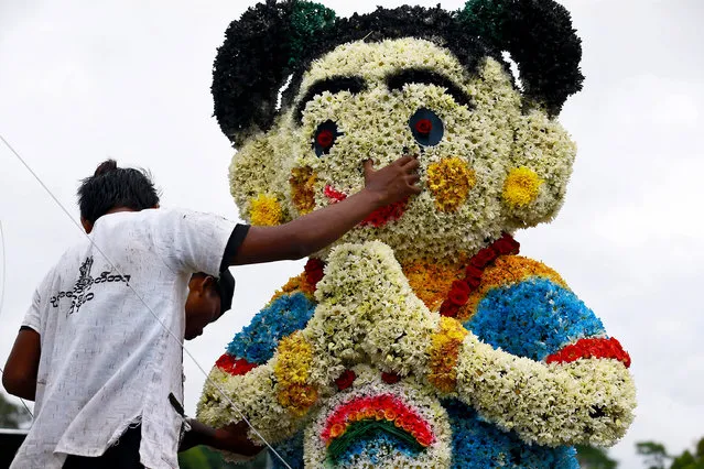 Workers set up a Myanmar traditional Thu Nge Daw dancer made of flowers during the opening of 70th The Netherlands-Myanmar Yangon Flower Parade in Yangon, Myanmar, 23 October 2018. The Netherlands-Myanmar Yangon Flower Parade is the very first in Myanmar and is being held from 23 to 25 October 2018. (Photo by Nyein Chan Naing/EPA/EFE)